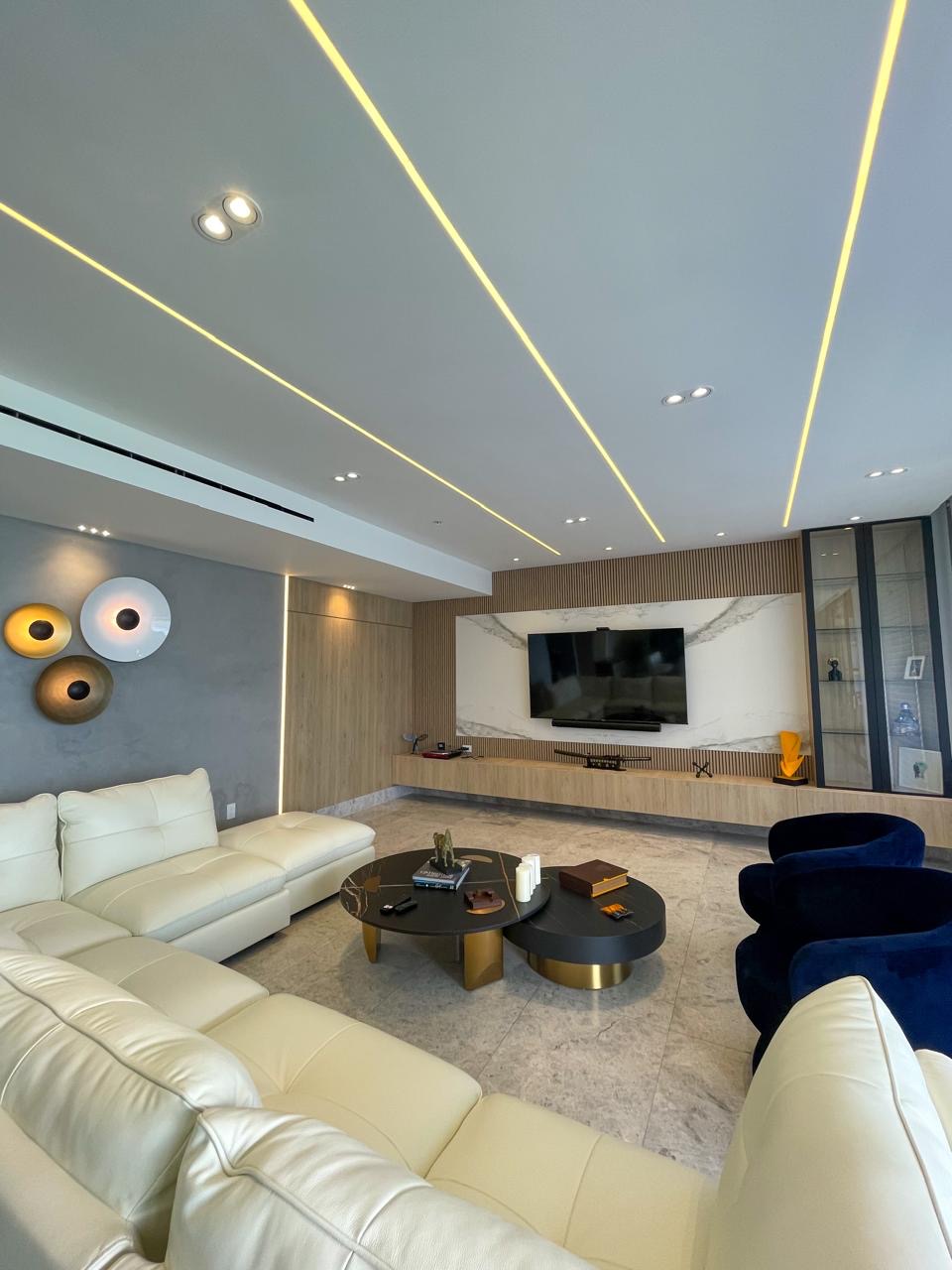 Main living room with marble panel, TV and backlit ceiling — PH Empire
