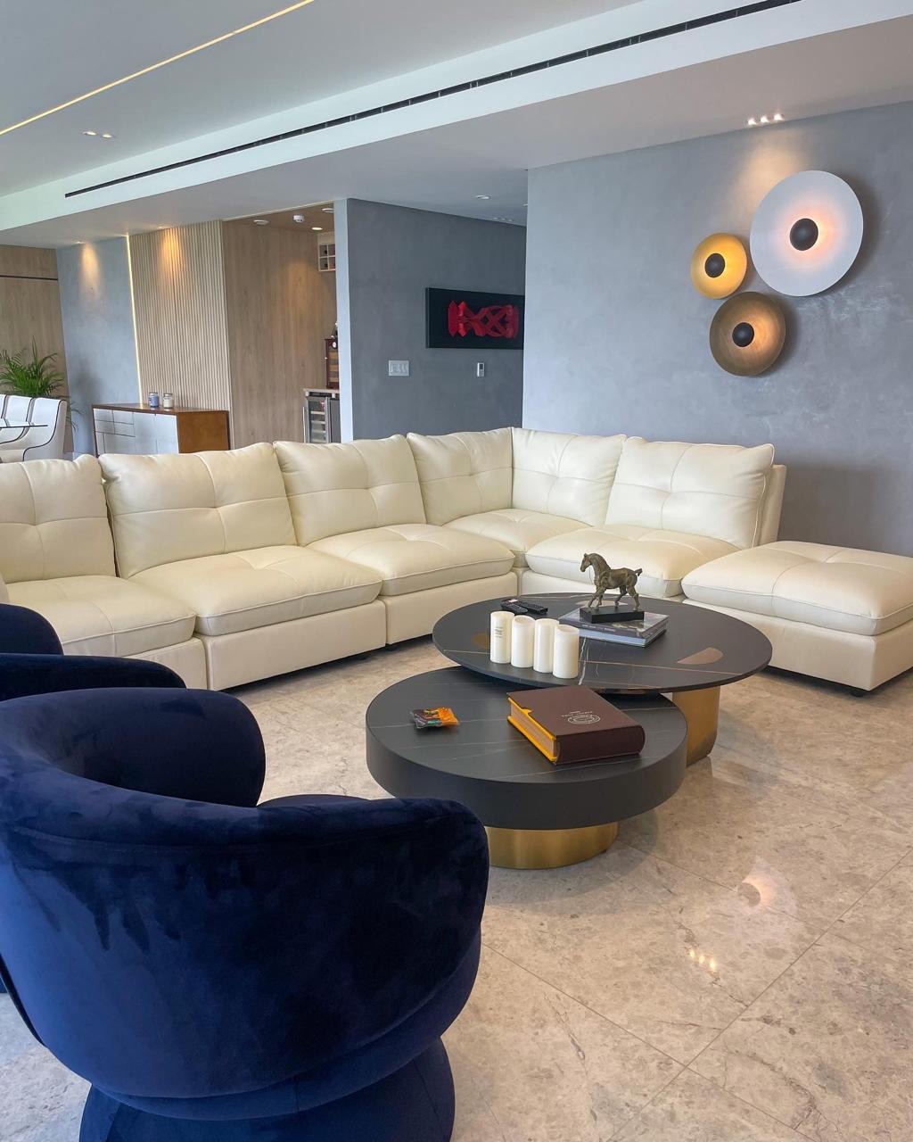 Lounge with off-white sofa, navy armchairs and wall art — PH Empire