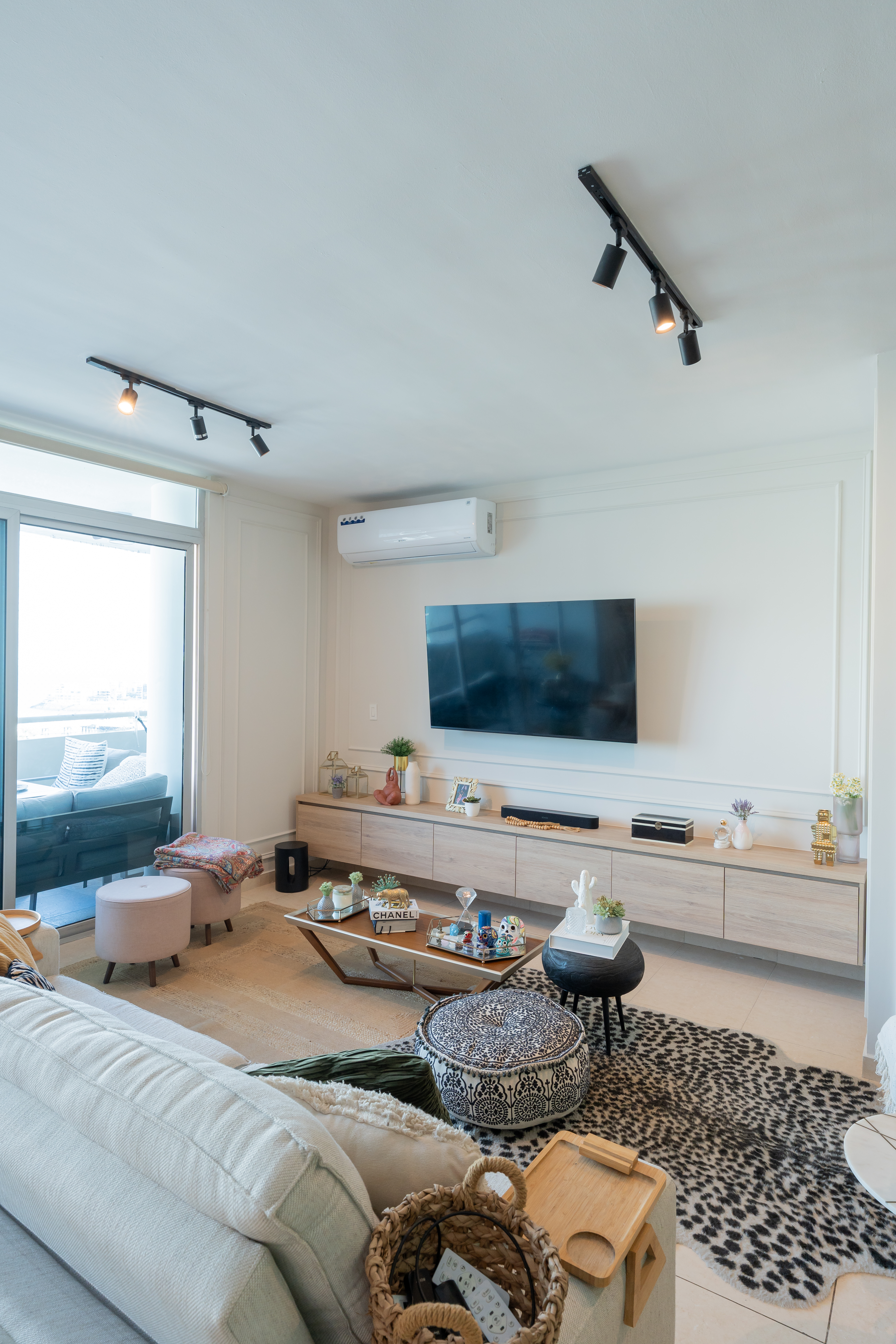 Sala con mueble de TV flotante y alfombra de leopardo — PH Torre del Parque