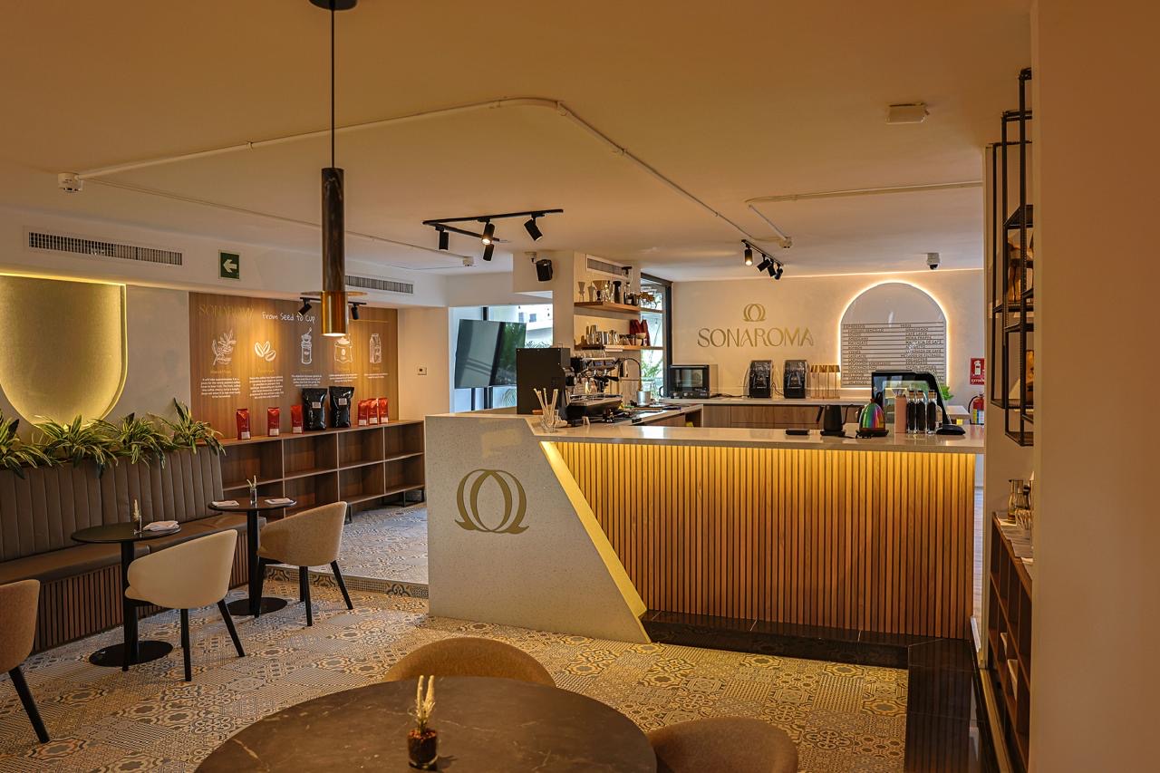 Coffee bar with slatted wood front and backlit arch — Sonaroma